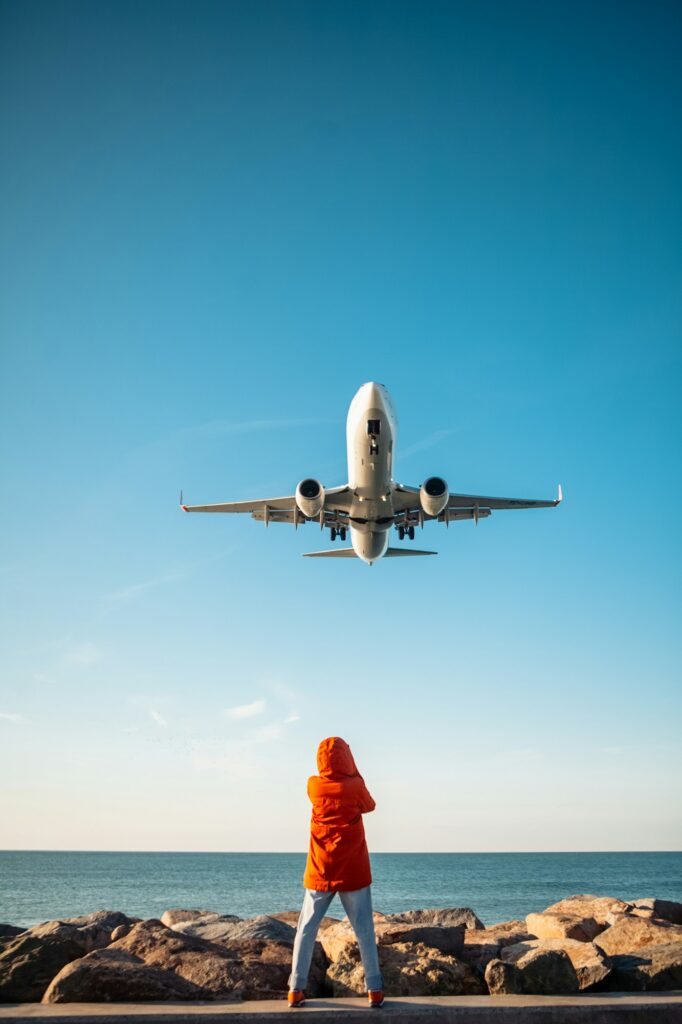 woman filming plane landing on phone